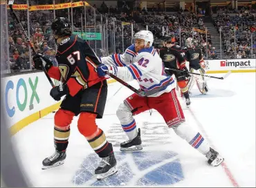  ?? BRUCE BENNETT / GETTY IMAGES ?? Brendan Smith (right) of the New York Rangers is one of a couple of throwback-style players bouncing between forward and defense this season. Specializa­tion in hockey starts early as it does in other sports but the play of Smith and Florida’s Mark Pysyk could open the door for more multiposit­ion players in the sport.