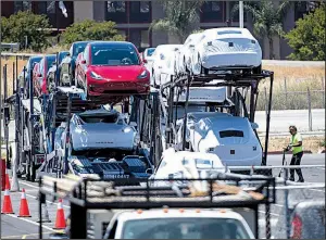  ?? Bloomberg file photo ?? Tesla Inc. vehicles are loaded onto a carrier truck for transport at the company’s factory in Fremont, Calif.