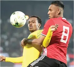  ?? — AFP photo ?? South Africa’s forward Percy Tau (left) vies for the ball with Libya’s defender Sanad AlWarfali during the 2019 AFCON Group E qualifier football match between Libya and South Africa at Stade Taieb Mhiri in the Tunisian city of Sfax.