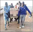  ?? AFP ?? People carry a coffin on the banks of Lake Victoria on Saturday.