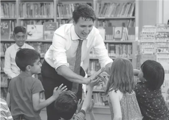  ?? JUSTIN TANG/THE CANADIAN PRESS ?? Prime Minister Justin Trudeau high fives students at Berrigan Elementary School after an event marking Multicultu­ralism Day in Ottawa last June. It was Trudeau’s father Pierre Trudeau, who first declared multicultu­ralism to be the official policy of...