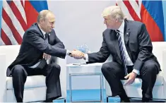  ??  ?? Hands on: Russian President Vladimir Putin with US President Donald Trump