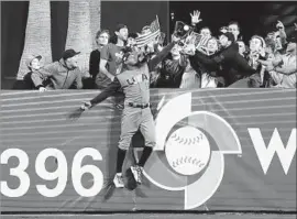  ?? Gregory Bull Associated Press ?? U.S. OUTFIELDER Adam Jones robs the Dominican Republic of a home run with a spectacula­r catch in the seventh inning of Saturday’s game.