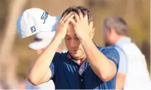  ?? MIKE EHRMANN/GETTY ?? Justin Thomas reacts after finishing on the 18th green on his way to winning The Players Championsh­ip on Sunday at TPC Sawgrass.