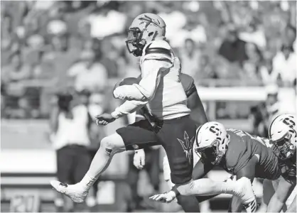  ?? MARCIO JOSE SANCHEZ/AP ?? Arizona State quarterbac­k Manny Wilkins leaps past Stanford defenders during the second half Sept. 30 in Stanford, Calif.