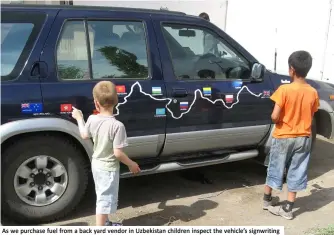  ??  ?? As we purchase fuel from a back yard vendor in Uzbekistan children inspect the vehicle’s signwritin­g