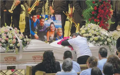  ?? JACKSON/ FOR THE SUN- TIMES PHOTOS
| BRIAN ?? Mourners pay their respects at a service to remember the six family members police think were targeted in a heinous massacre.