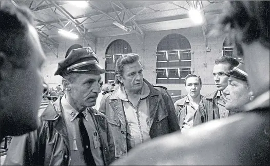  ??  ?? Country star Johnny Cash goes behind bars for famous concert at San Quentin prison in 1969