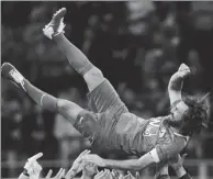  ?? DANIELE MASCOLO / REUTERS ?? Former AC Milan and Italy star Andrea Pirlo is hoisted by teammates at the end of his farewell match at San Siro stadium in Milan on Monday.