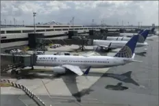  ?? Seth Wenig/Associated Press ?? United Airlines planes are parked at gates July 1 at Newark Liberty Internatio­nal Airport in Newark, N.J. Congress’ $900 billion pandemic relief package, which passed Monday, includes $15 billion for the airline industry.