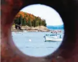  ??  ?? Bar Harbor, Maine is seen through a rusting boat cleat attached to a dock. — AP photos