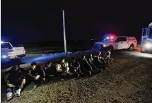  ?? Gregory Bull/Associated Press ?? Migrants wait to be processed to seek asylum after crossing the border into the United States on Friday near Yuma, Ariz.