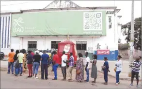  ??  ?? Voters line up in front of a polling station during the second round of the presidenti­al election in Bissau, yesterday.