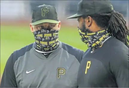  ?? ASSOCIATED PRESS FILE PHOTO ?? Pittsburgh Pirates first baseman Josh Bell, right, listens to manager Derek Shelton during a July 7 team workout at PNC Park in Pittsburgh. Shelton and other first-year managers are scrambling to make up for lost time. The rookie skippers are getting creative when it comes to getting a feel for their players during a season unlike any other.