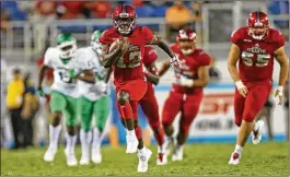  ?? JOEL AUERBACH / GETTY IMAGES ?? FAU’s John Franklin III runs for a 55-yard touchdown during the fourth quarter of a 69-31 victory against North Texas on Saturday in Boca Raton.