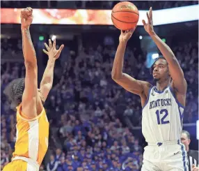  ?? AP ?? Kentucky’s Antonio Reeves shoots over Tennessee’s Zakai Zeigler on Saturday in Lexington, Ky.