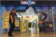  ?? SADIQ ASYRAF — THE ASSOCIATED PRESS ?? A man walks in front of the Toys R Us store at a shopping mall in Subang Jaya, Malaysia, Thursday.