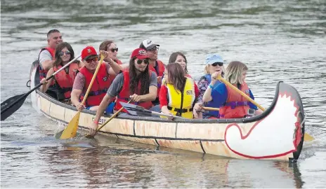  ?? MATT OLSON ?? Minister of Crown-Indigenous Relations Carolyn Bennett, second from front in a blue life-jacket, arrives at Batoche in a canoe with Metis youth from across Canada for a historic signing ceremony Friday. Metis Nation-Saskatchew­an president Glen McCallum...