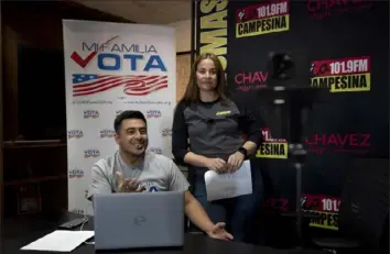  ?? Serkan Gurbuz/Associated Press ?? Staff members Michael Ruiz, left, and Marisol Moraga participat­e in a phone bank event at La Campesina, a Spanish-language radio network in Phoenix, on March 20.