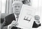  ?? AP ?? President Trump signed the tax cut bill Dec. 22. Since then, many companies have bought back their own stock.