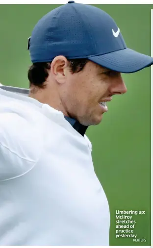  ?? REUTERS ?? Limbering up: McIlroy stretches ahead of practice yesterday