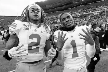  ?? PAUL SANCYA/AP ?? Ohio State defensive end Chase Young (2) and cornerback Jeff Okudah (1) celebrate after the Buckeyes’ win over Michigan on Saturday.