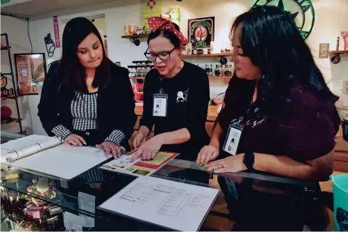  ?? PHOTOS BY MARIANNE TODD/THE NEW MEXICAN ?? ABOVE: Bobbi Martinez, from left, looks through a cannabis compliance book with Mary Jean Garcia and Laura Legarda on Dec. 9 at La Tiendita de Motita in Albuquerqu­e’s South Valley neighborho­od. Martinez was the state’s first cannabis compliance officer and now helps clients through a consulting firm, Weeds. The owners of La Tiendita de Motita are former teachers who sold cars and cashed in retirement accounts to open the business. BELOW: Jamie Munsey, an operator at La Tiendita de Motita along with four other women, stands outside the dispensary Dec. 29. Munsey and her partners say the state requires them to have a social equity plan but has failed to follow through on its own, which would have afforded them additional benefits as minorities.