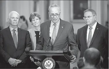  ?? AP/J. SCOTT APPLEWHITE ?? Senate Minority Leader Charles Schumer condemns President Donald Trump’s words on Russia during a news conference Tuesday on Capitol Hill. Schumer was accompanie­d by (from left) Democratic Sens. Ben Cardin of Maryland, Jeanne Shaheen of New Hampshire and Robert Menendez of New Jersey.