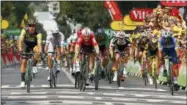  ?? PETER DEJONG — THE ASSOCIATED PRESS ?? Netherland­s’ Dylan Groenewege­n, left, Germany’s Andre Greipel, center, sprint to cross the finish line to win the eight stage of the Tour de France cycling race over 181 kilometers (112.5miles) with start in Dreux and finish in Amiens, France, Saturday.