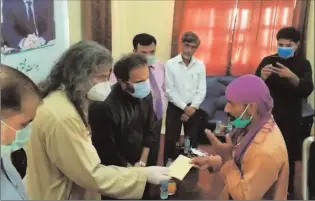  ?? DERA BUGTI
-APP ?? MD Pakistan Bait ul Mal Aon Abbas pubbi along with MNA Nawabzada Shahzain Bugti distributi­ng cheques among the needy persons in Dera Bugti, Quetta.
