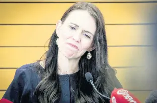  ?? AP ?? New Zealand Prime Minister Jacinda Ardern grimaces as she announces her resignatio­n at a press conference in Napier.