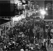  ?? ASSOCIATED PRESS ?? IN THIS 2017 FILE PHOTO, throngs of revelers are seen from the balcony of the Royal Sonesta Hotel on Bourbon Street Mardi Gras evening in New Orleans.