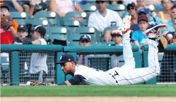  ?? PAUL SANCYA/AP PHOTO ?? Detroit Tigers left fielder Victor Reyes dives but can’t hold onto a Cleveland Indians Edwin Encarnacio­n single in the eighth inning Sunday in Detroit.