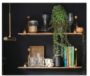  ??  ?? Open shelving from Naken provides additional storage where wall units would have been too bulky, and warms up the dramatic black wall with wood and gold tones