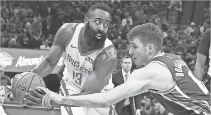  ?? KELLEY L. COX/USA TODAY SPORTS ?? Rockets guard James Harden, defended by the Kings’ Bogdan Bogdanovic, had a recent streak of 32 games with at least 30 points.