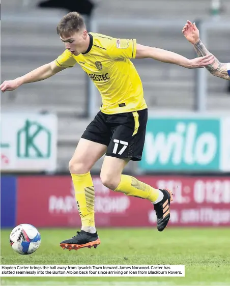  ??  ?? Hayden Carter brings the ball away from Ipswich Town forward James Norwood. Carter has slotted seamlessly into the Burton Albion back four since arriving on loan from Blackburn Rovers.