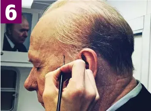  ??  ?? Lifelike: Make-up supervisor David Malinowski gets his paint brush out to add on Churchill’s blotches, veins, moles and blemishes