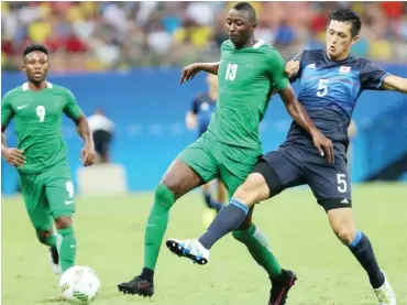  ??  ?? Nigeria’s Sadiq Umar vies for the ball with a Japanese player during the football event of the Rio Olympic Games