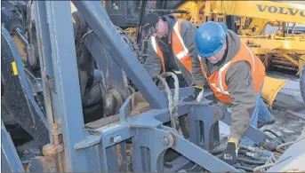  ?? SAM MACDONALD/THE NEWS ?? Gavin Raniowski, left, and Jeff Deyoung, with the New Glasgow department of engineerin­g and public works, check up on some of the vehicles that will be used to clear some of the snow that today’s storm is anticipate­d to dump on Pictou County and the...