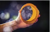  ?? TRAVEL BUTLER COUNTY — RVP PHOTOGRAPH­Y VIA AP ?? A donut with toppings representi­ng an eclipse is displayed at the Donut Dude shop on March 8in Liberty Township, Ohio.