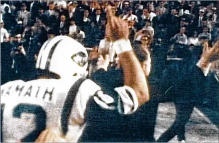  ?? NFL PHOTOS ?? SUPER BOWL III New York Jets Hall of Fame quarterbac­k Joe Namath signals that the Jets are No. 1 after a 16-7 win over the Baltimore Colts in Super Bowl III in January 1969 at Miami’s Orange Bowl. Noted Sports Illustrate­d photograph­er Walter Iooss considers this his personal favorite of all Super Bowl photos: “It’s dreamlike. Somehow, it captures the fleeting moment of Joe.”