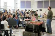  ?? JONATHAN TRESSLER — THE NEWS-HERALD ?? Madison Schools band director Brett Tomko talks trombones to one of his high-school band classes during Trombone Day March 31.