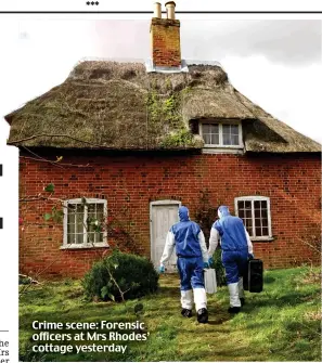  ??  ?? Crime scene: Forensic officers at Mrs Rhodes’ cottage yesterday