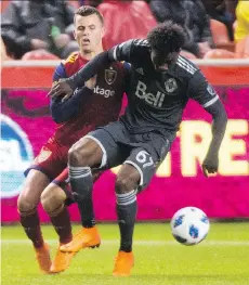  ?? RICK EGAN/THE SALT LAKE TRIBUNE VIA THE ASSOCIATED PRESS ?? RSL’s Brooks Lennon, left, challenges the Caps’ Alphonso Davies on Saturday.