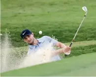  ?? AP ?? Kyle Stanley hits out of the bunker on the 18th hole. —