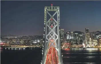  ?? Anadolu Agency via Getty Images ?? THE LIGHTS that run along the western side of the San Francisco Bay Bridge will come down Sunday. “It’s going to leave a hole in the sky,” said the founder of a nonprofit that helped launch the decade-long art project.