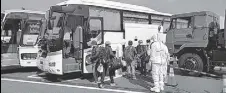  ?? AP ?? Filipino crew members leaving the quarantine­d Diamond Princess cruise ship at Yokohama Port in Japan on Tuesday.