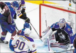  ?? David Zalubowski The Associated Press ?? Blues center Robert Thomas (18) scores against Avalanche goalie Darcy Kuemper with 56 seconds left in the third period Wednesday.