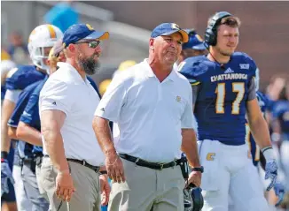  ?? STAFF PHOTO BY DOUG STRICKLAND ?? UTC football coach Russ Huesman, center, says his fourth-ranked Mocs will “get tested against Furman.”