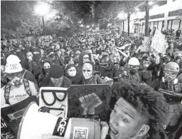  ?? NOAH BERGER/AP ?? Black Lives Matter protesters march through Portland, Ore., after rallying at the city’s federal courthouse last Aug. 2.